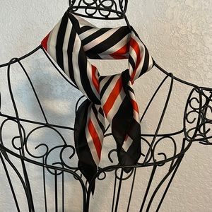100% Silk scarf with simple black, white and red design.
